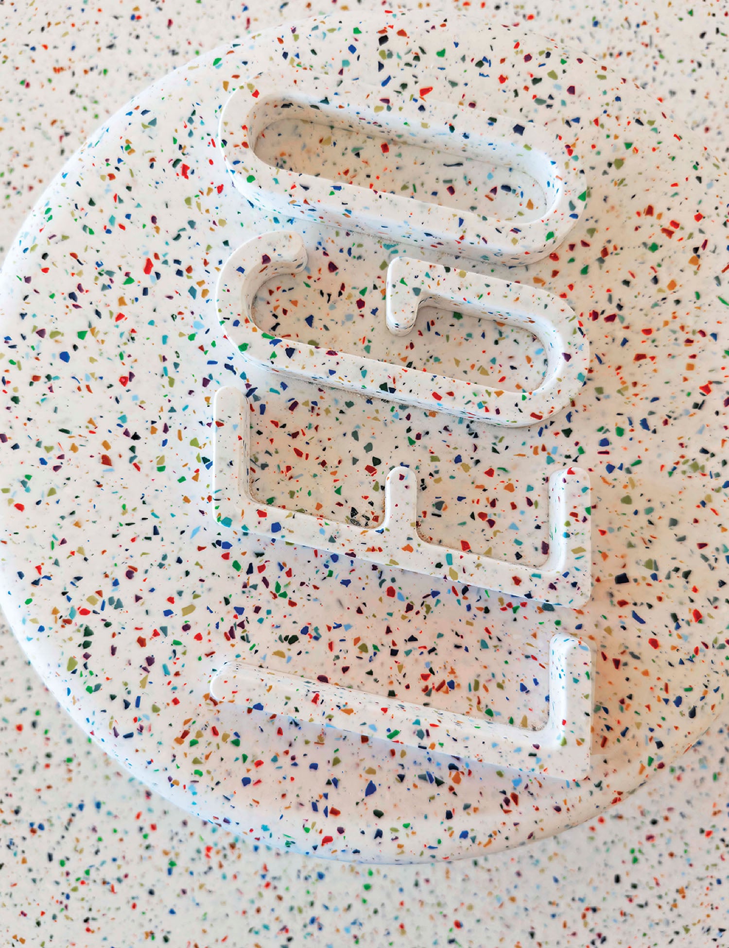 A white plastic object with confettin spe.