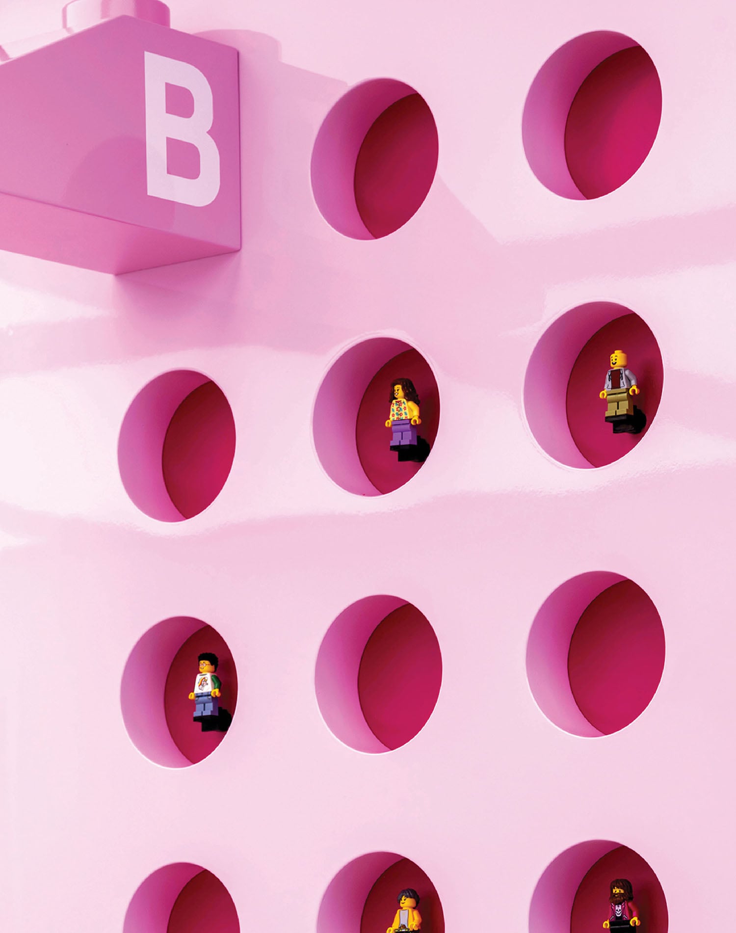 A pink wall with a bunch of people in it.