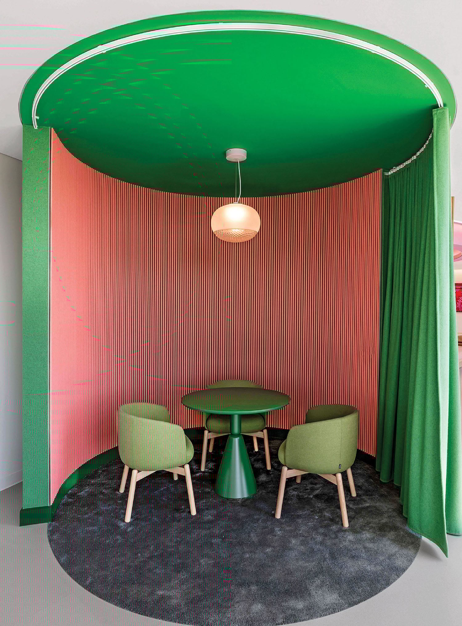 A green table and chairs in a room.