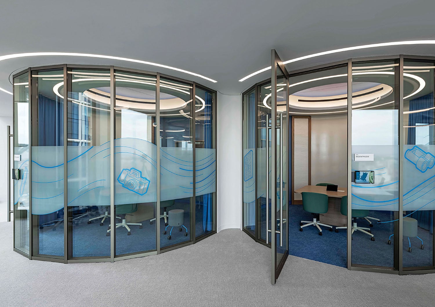 A glass office with a curved wall.