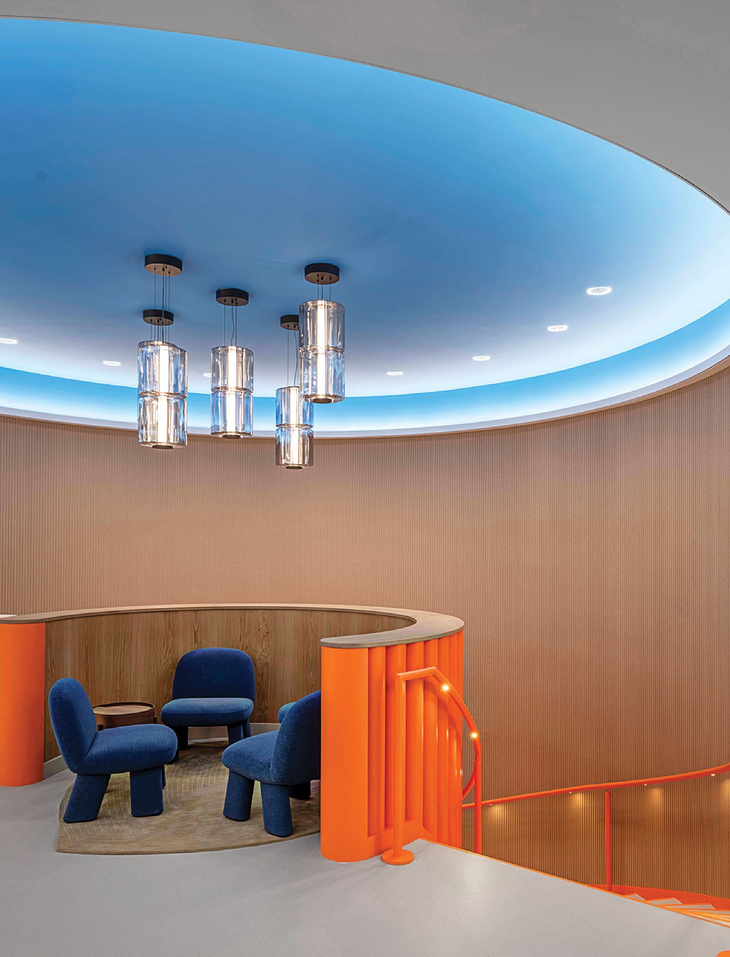 A room with a round table and chairs.