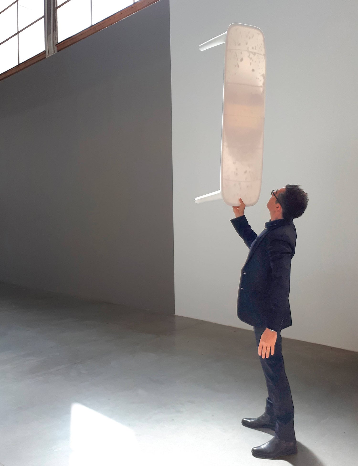 A man holding a skateboard in his hand.