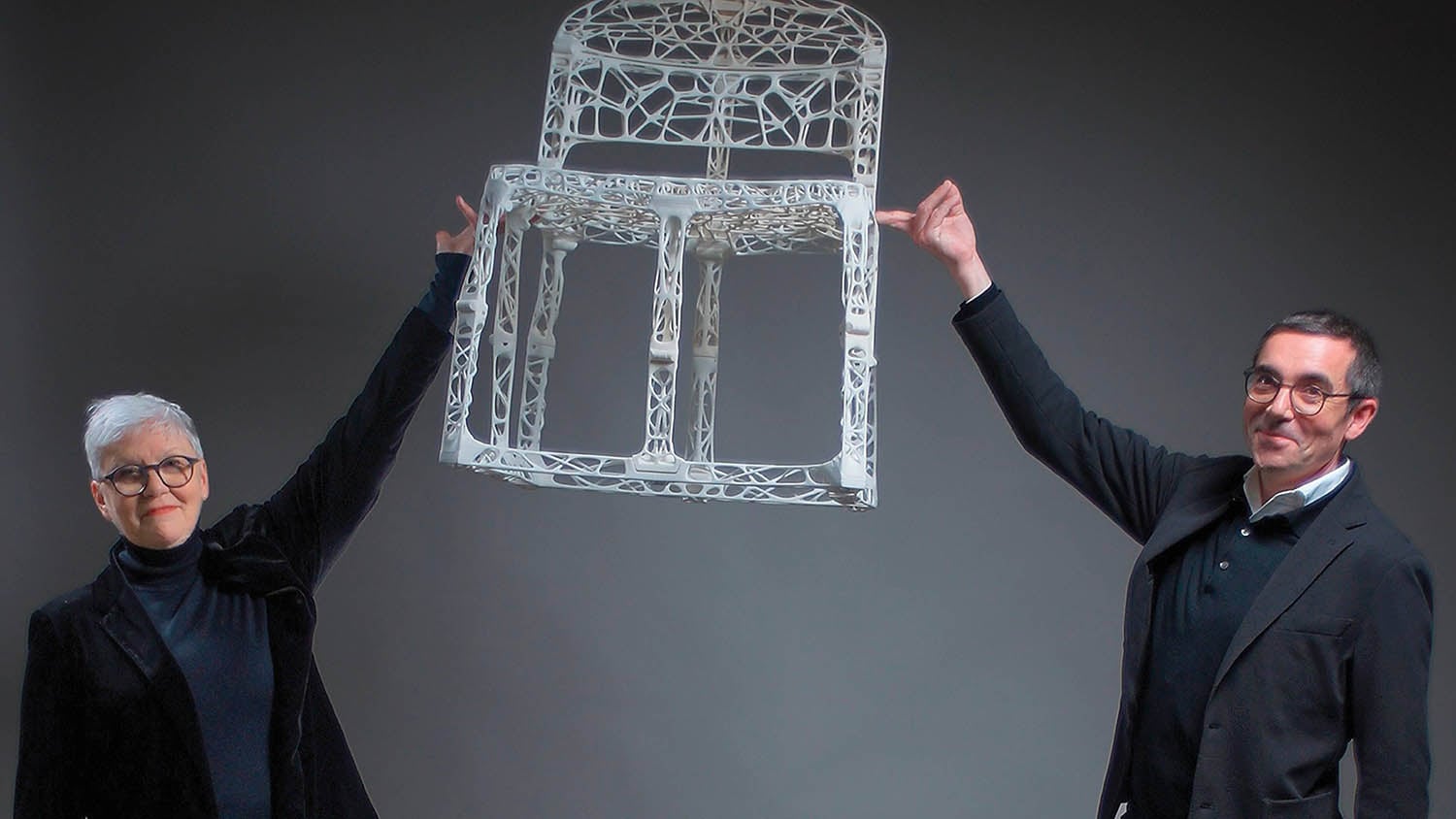 A man holding a chair.