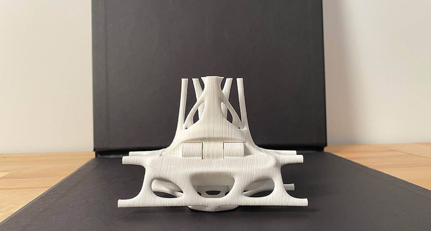 A white model of a car on a table.