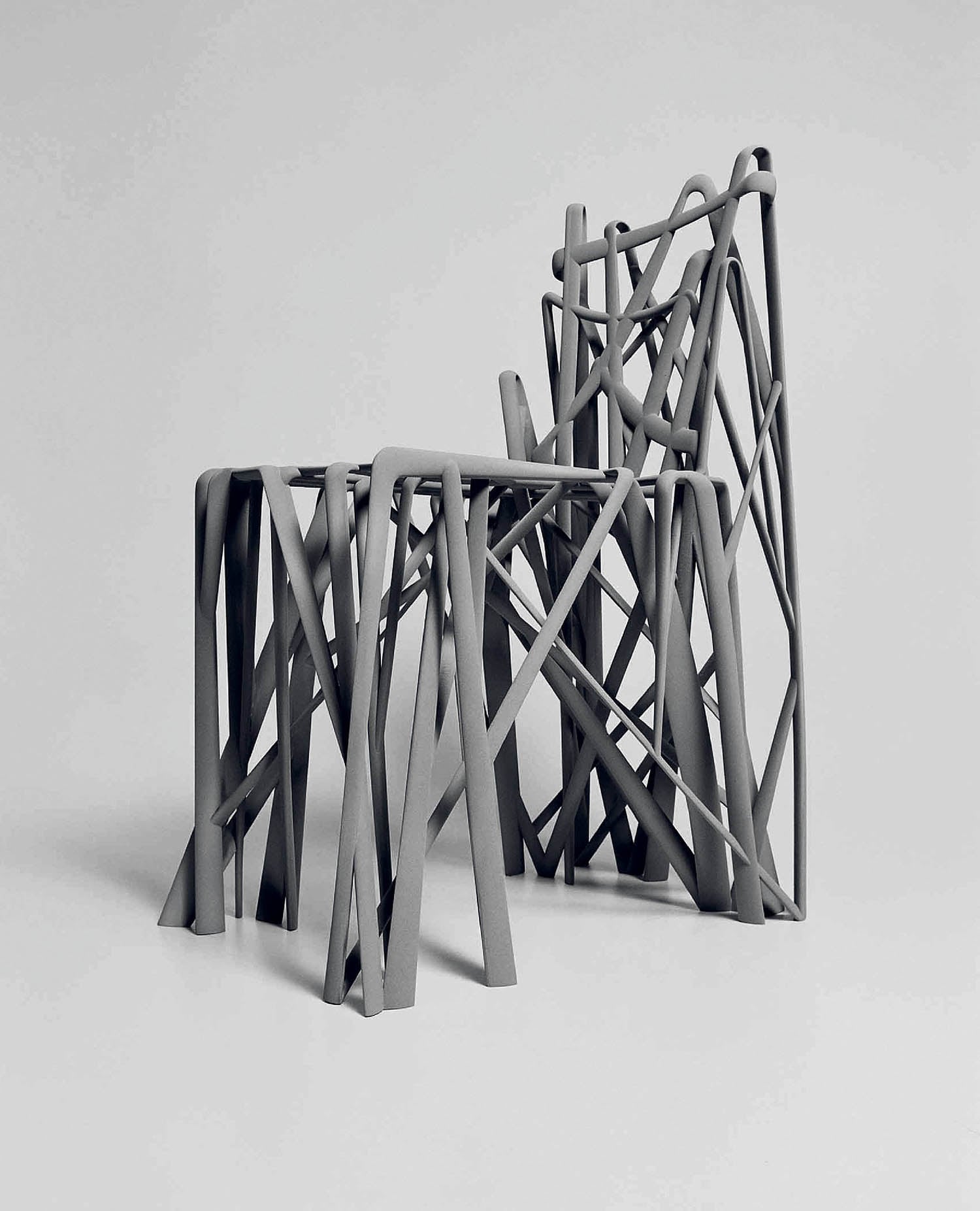 Three black and white sculptures on a white background.