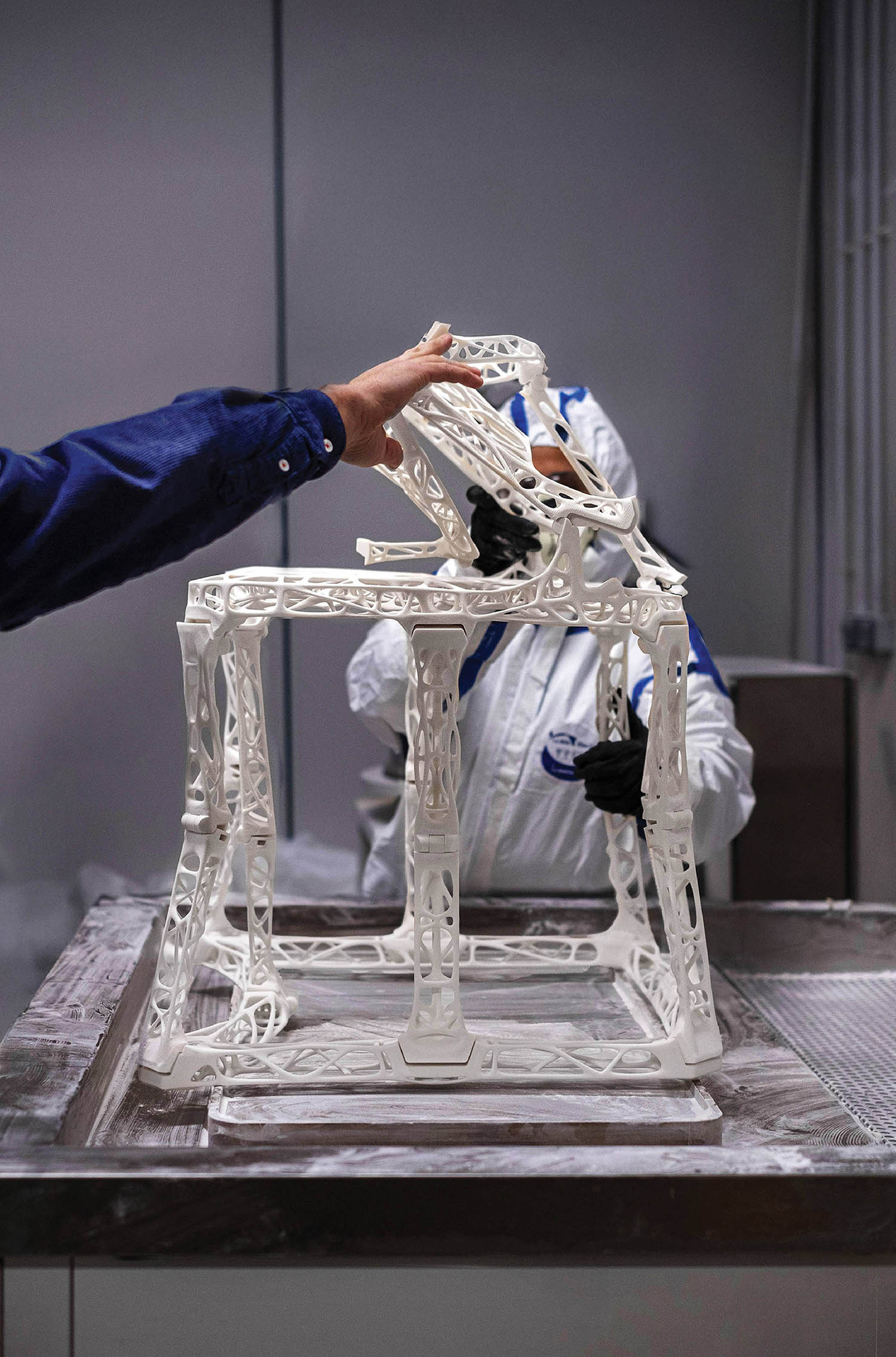 A man working on a sculpture of a horse.