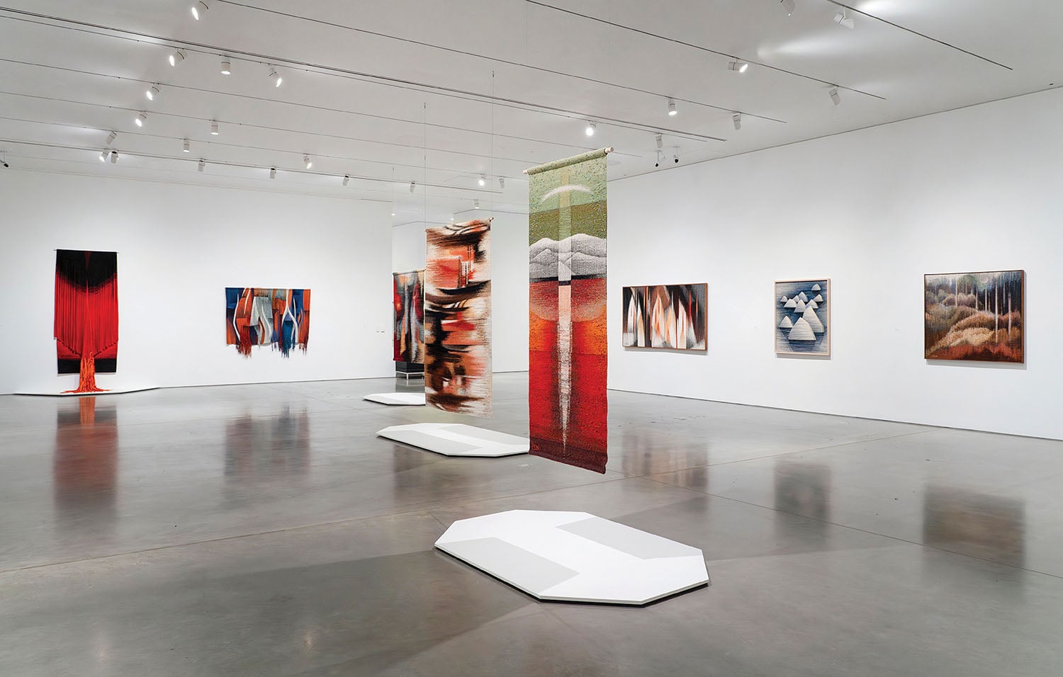 A room with a large painting on the wall.