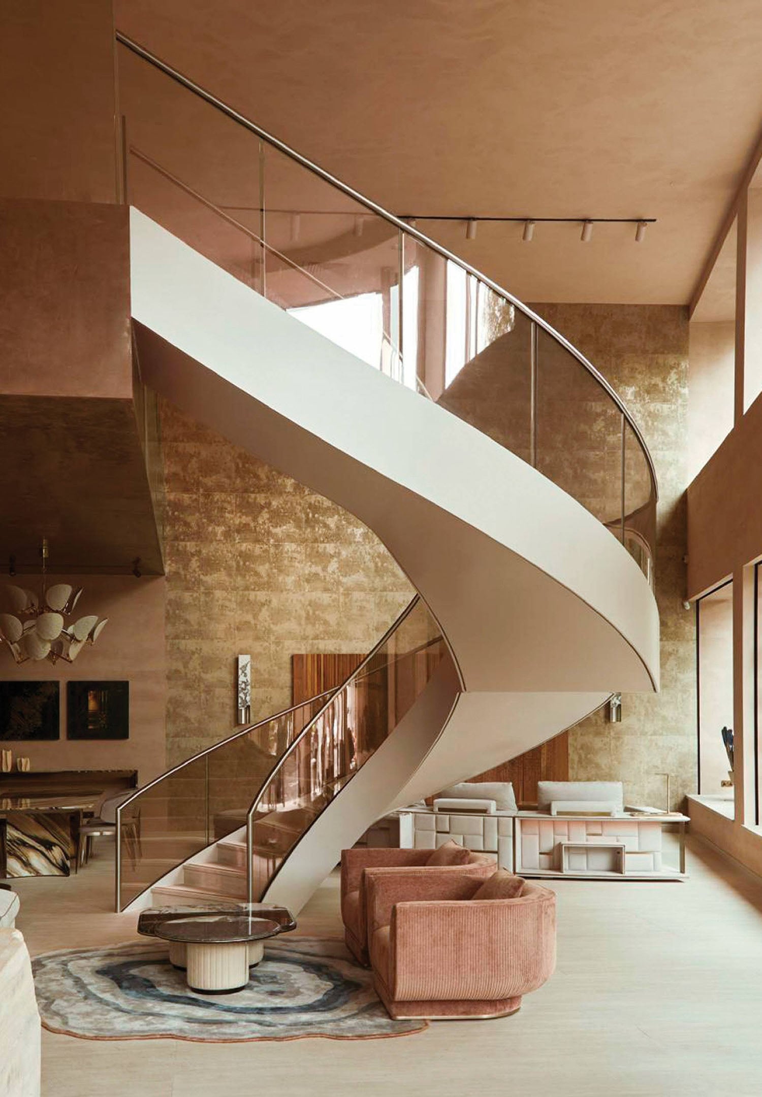 A modern staircase with a curved metal handrail.