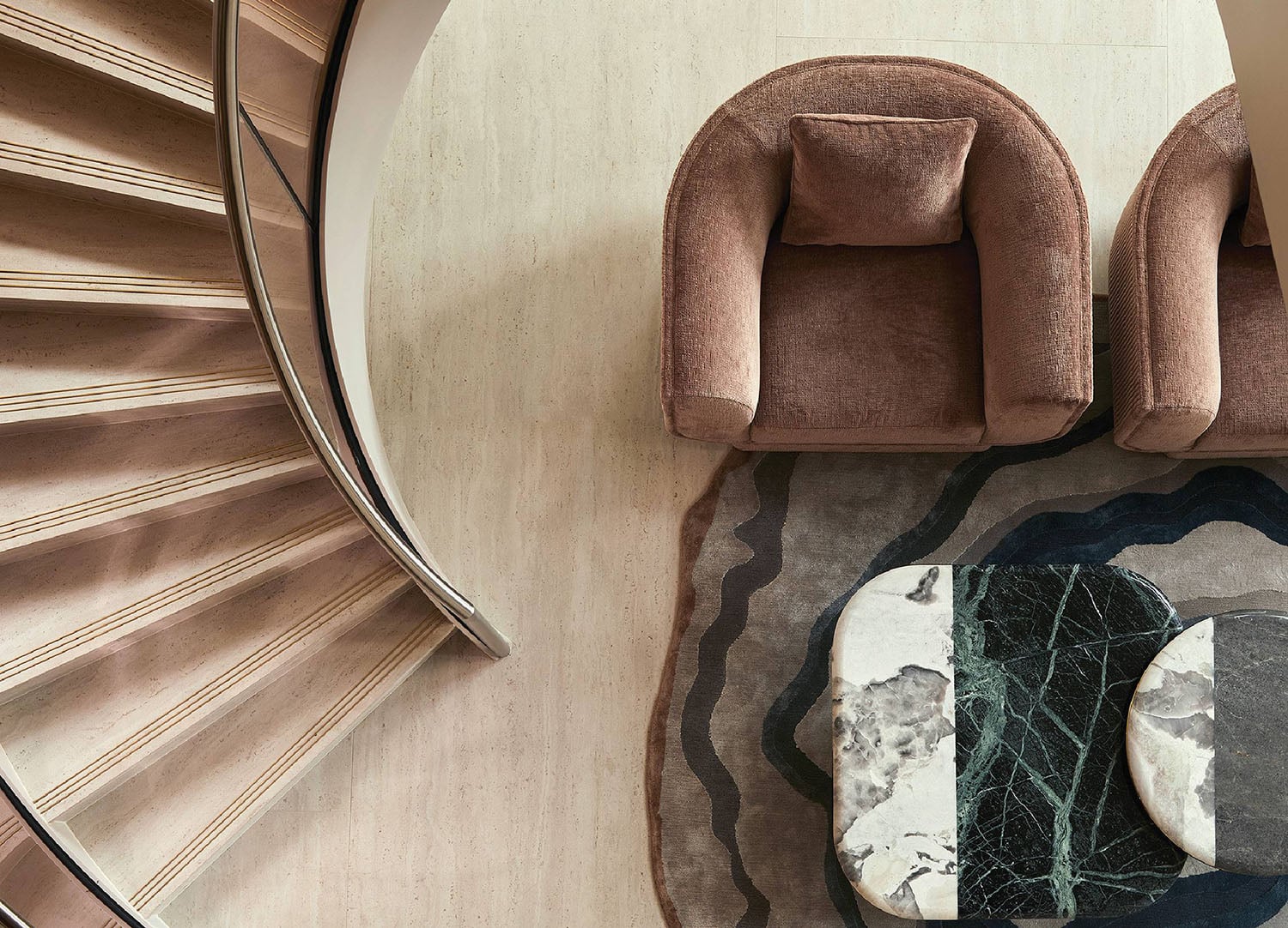 A spiral staircase with a marble floor and a marble table.