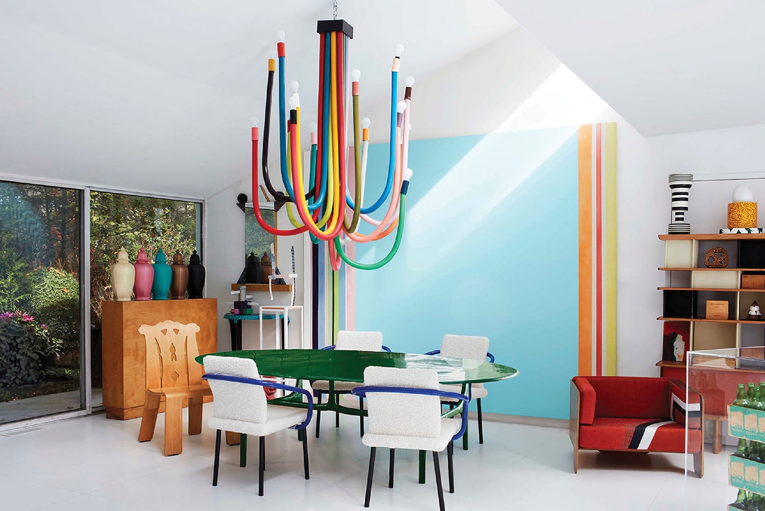 A colorful dining room with a colorful chandel.