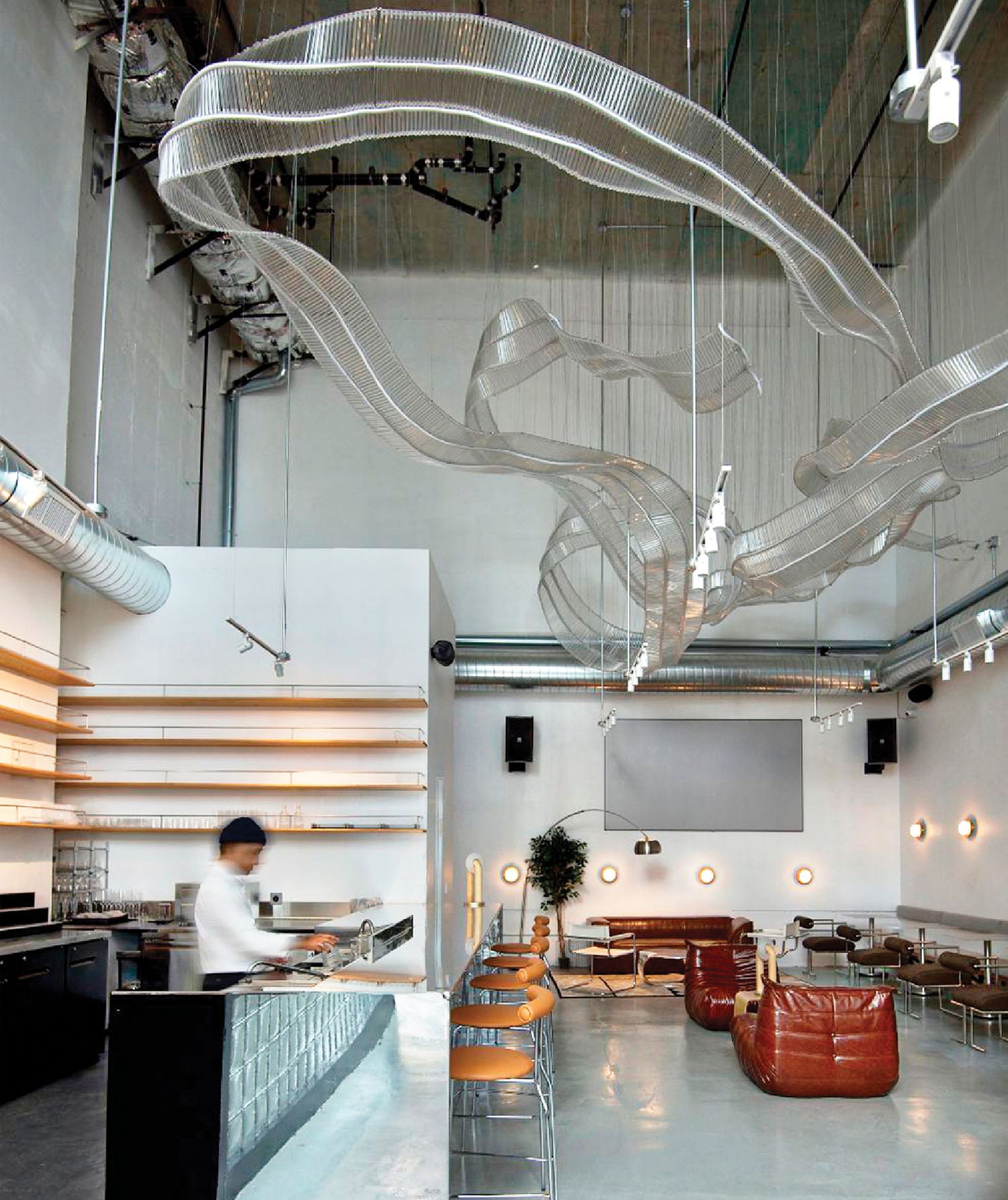 A large room with a lot of chairs and a large screen.