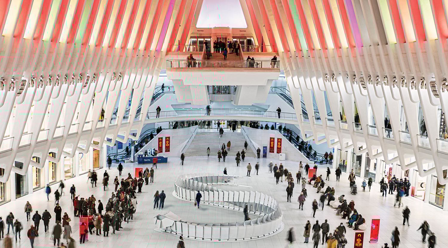A large group of people walking around a building.