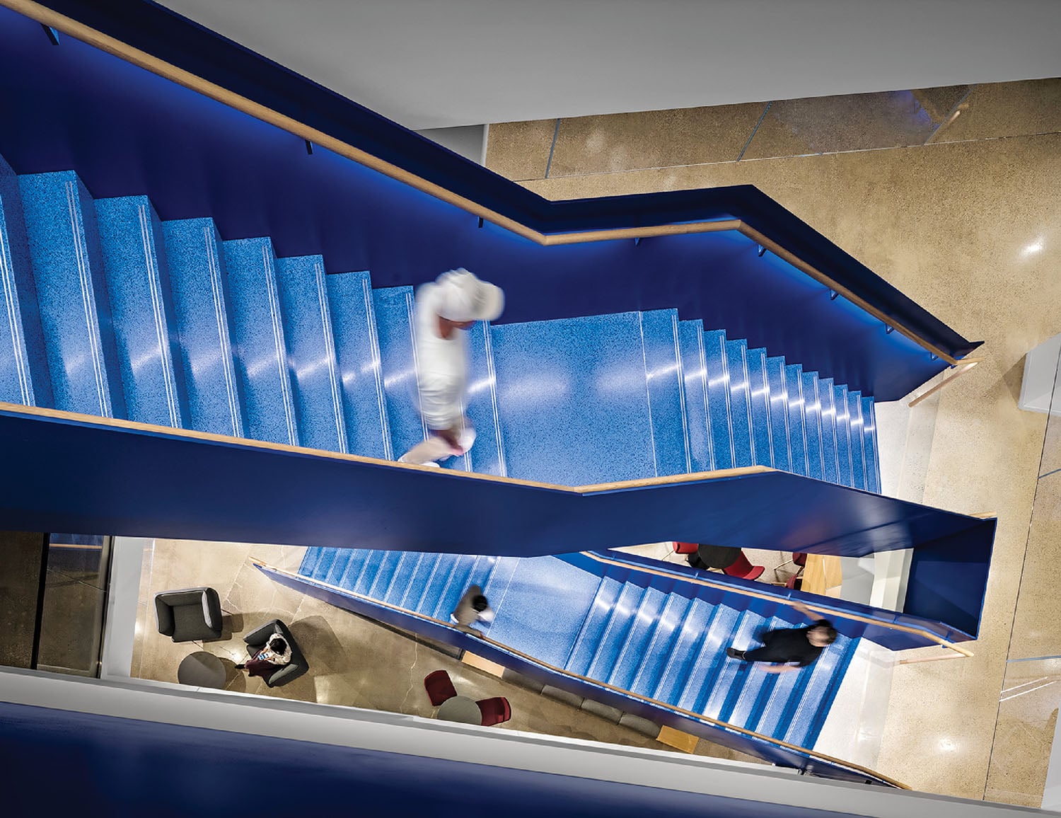 A group of people walking up a set of stairs.