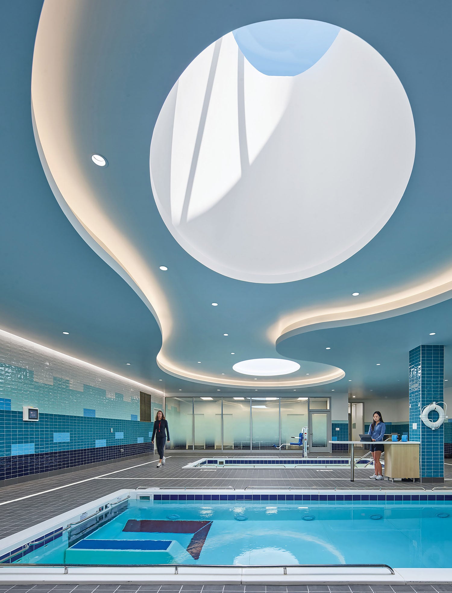 A swimming pool with a skylight above it.