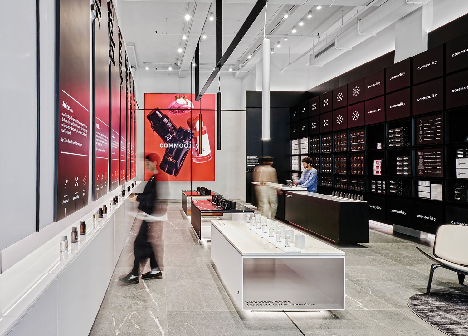 A man walking through a store with a large display.