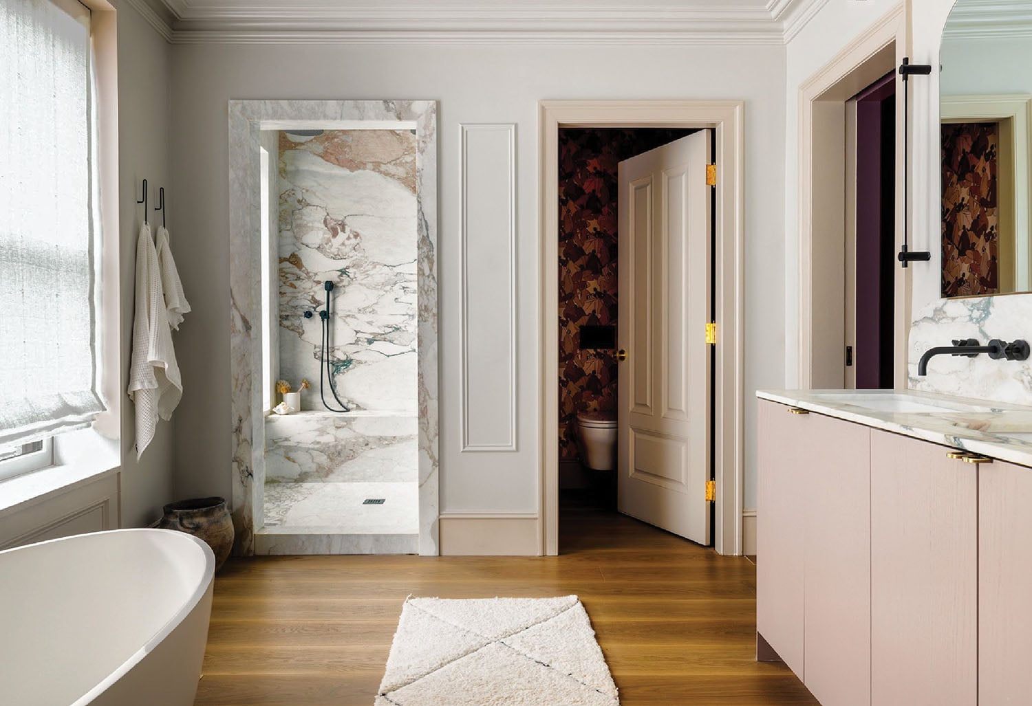 A bathroom with a bathtub and a rug.