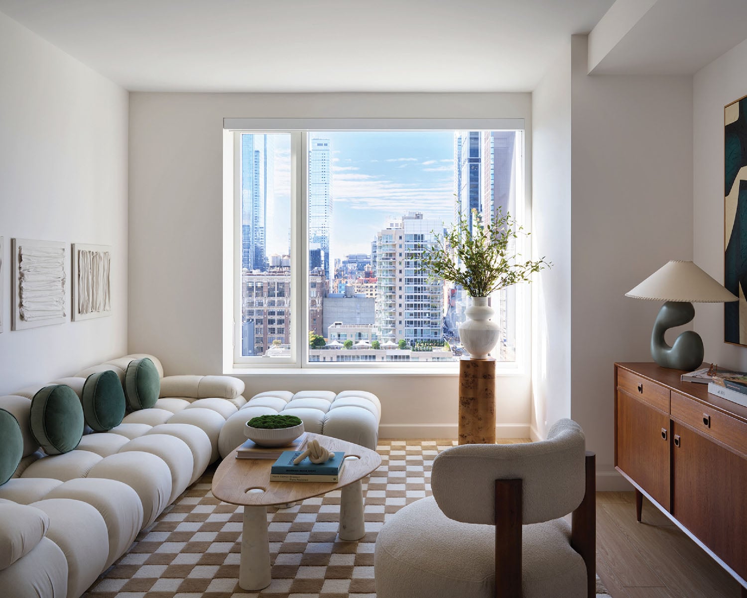A living room with a checkered floor and a large window.