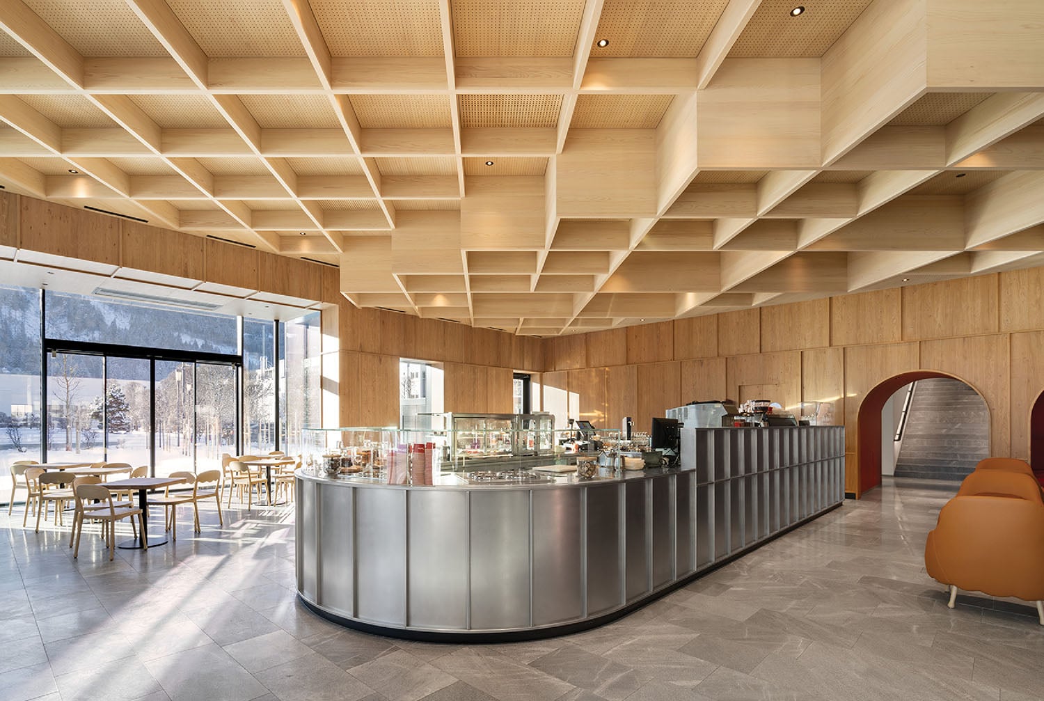 A restaurant with a large counter and a bar.