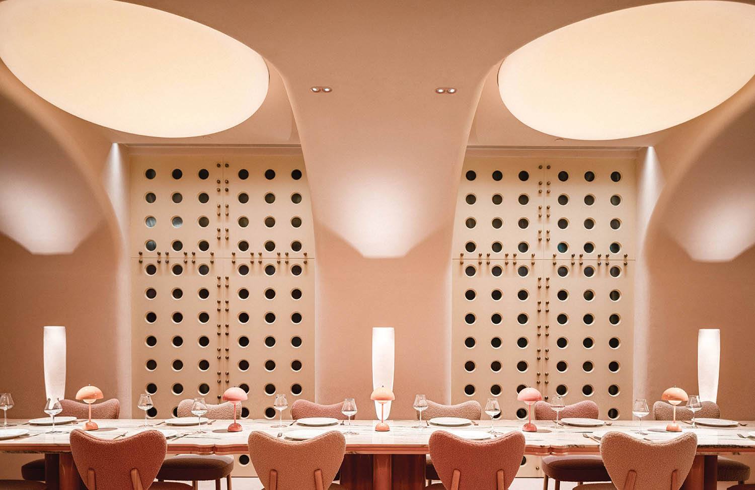 A dining room with a table and chairs.