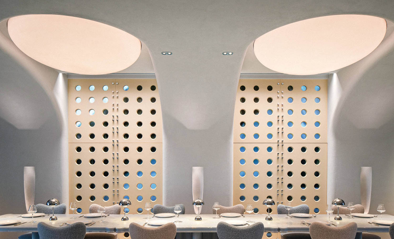 A restaurant with a large table and chairs.