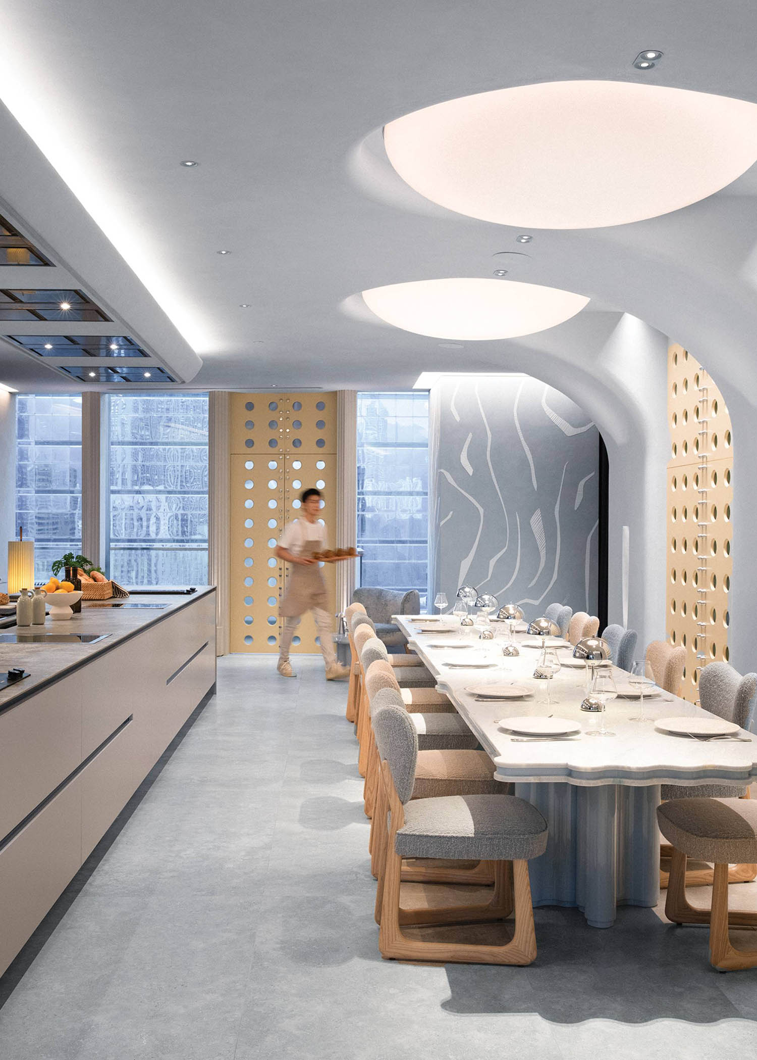 A dining room with a long table and chairs.
