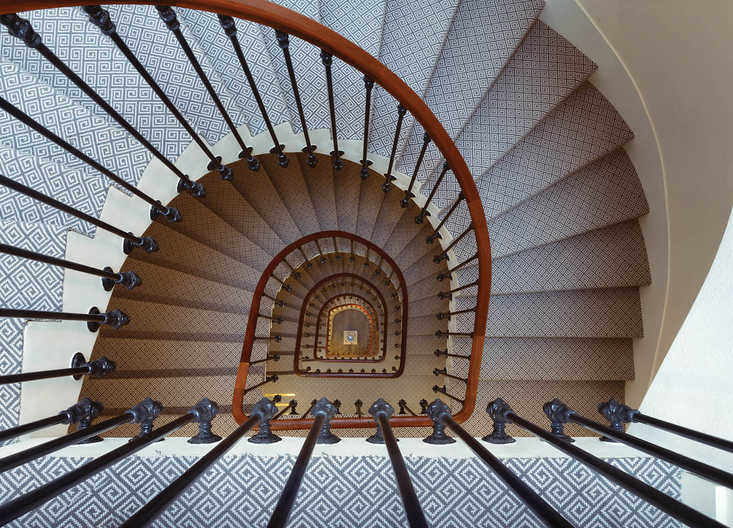 A spiral staircase with a tiled floor.