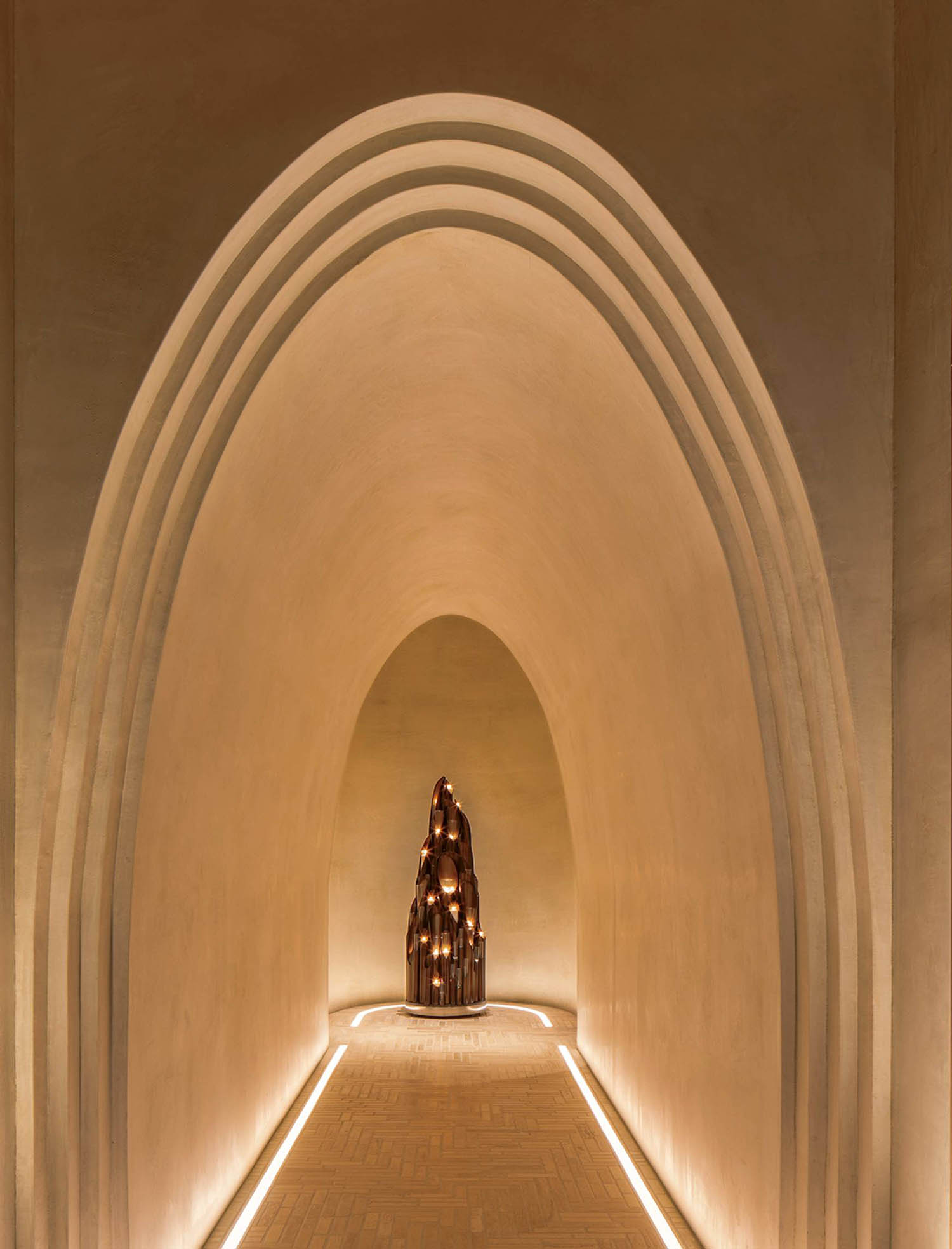 A long hallway with a statue in the middle.