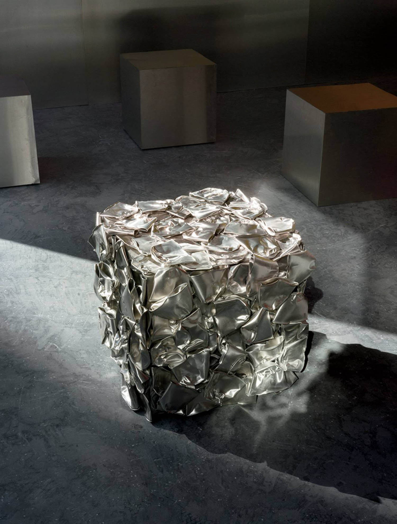 A silver cube with a lot of silver foil on it.
