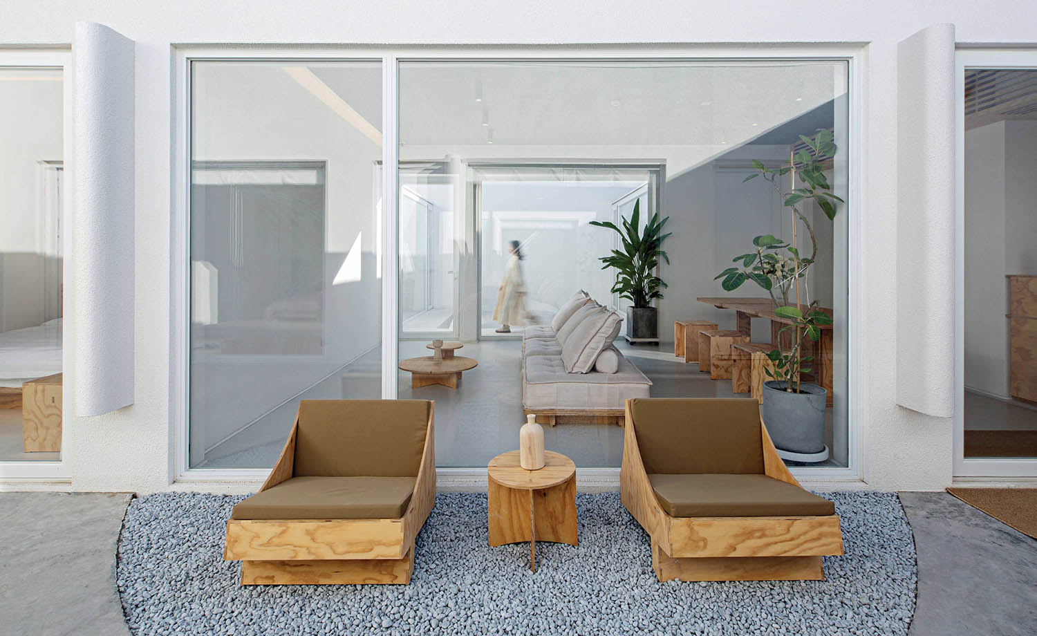 A living room with a couch and chairs.
