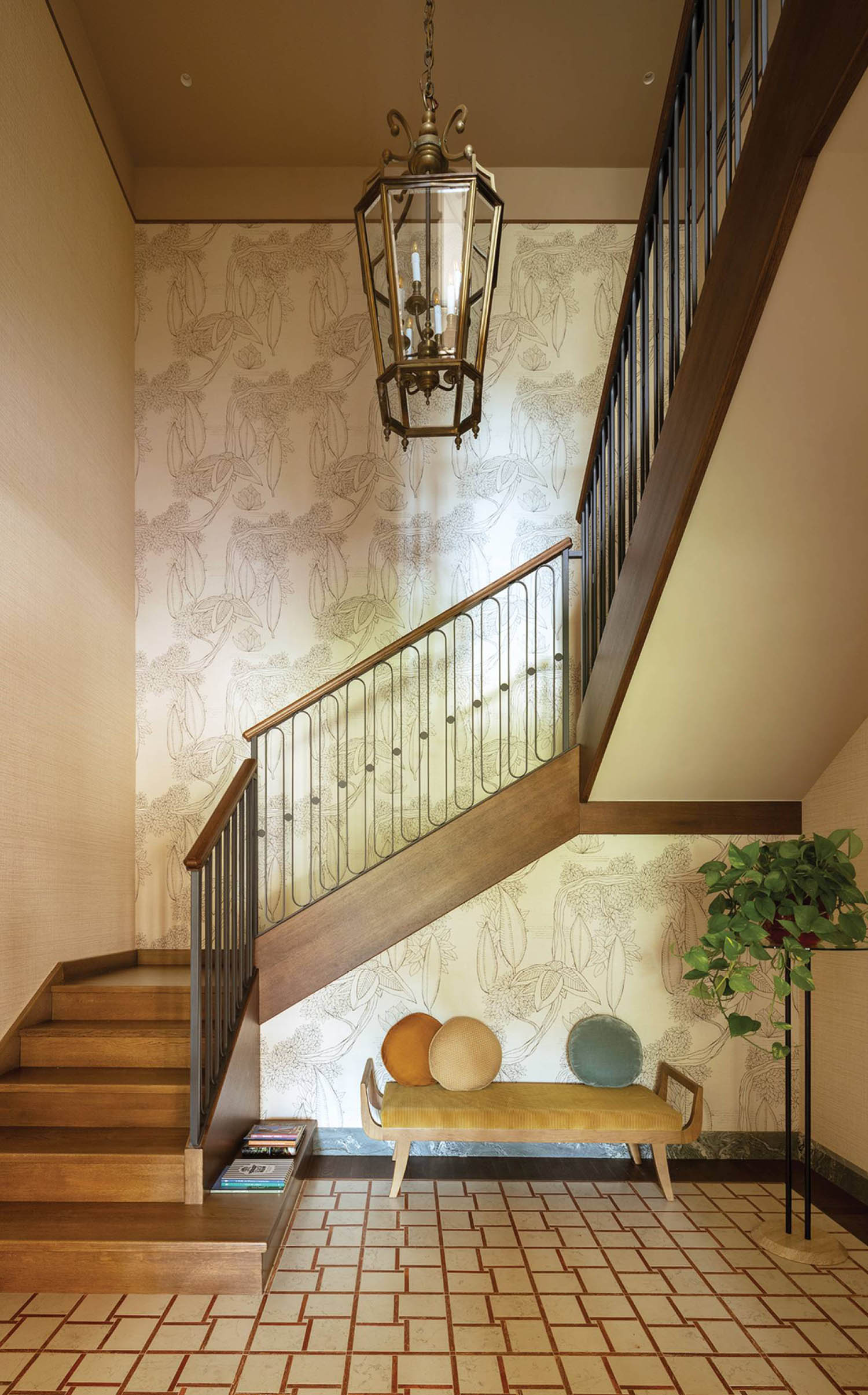 A staircase with a wallpapered wall and a wooden bench.