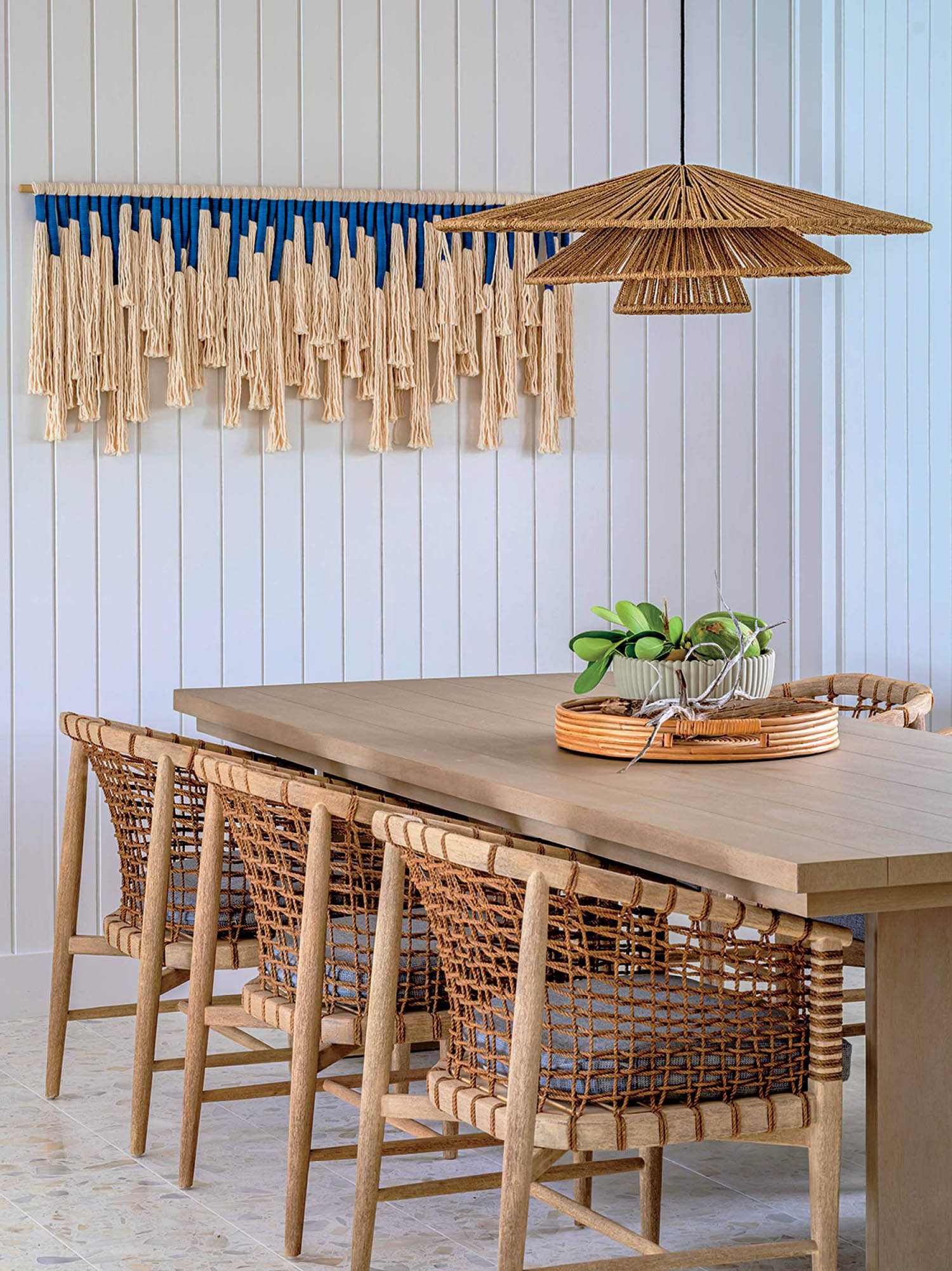 A dining table with a basket on it.