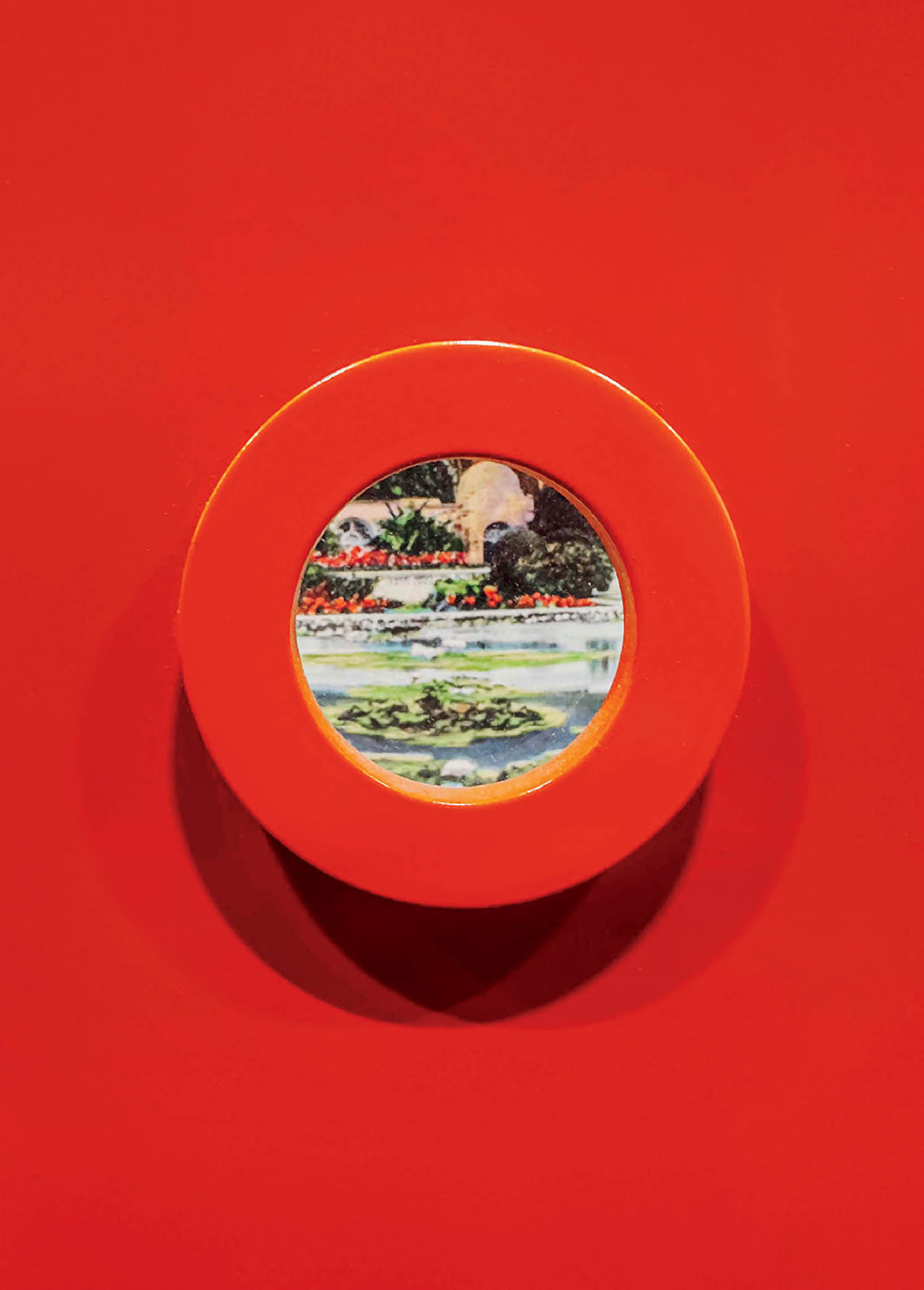 A red plate with a picture of a beach.