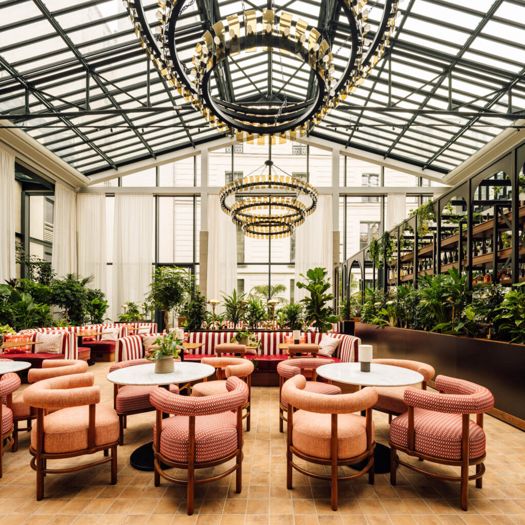 restaurant in a greenhouse setting with striped chairs