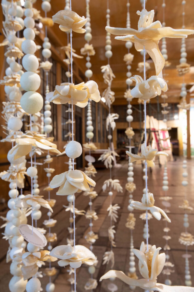strands of seashells in shapes of birds