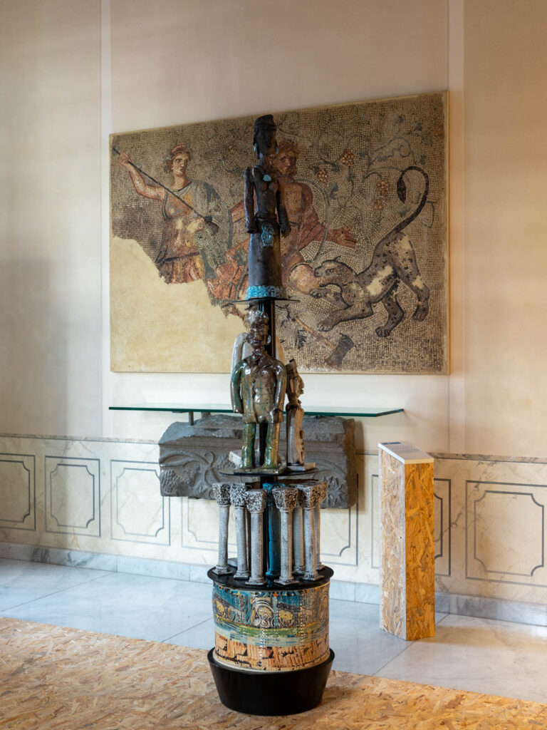 a sculptural lamp with a person carved into the base
