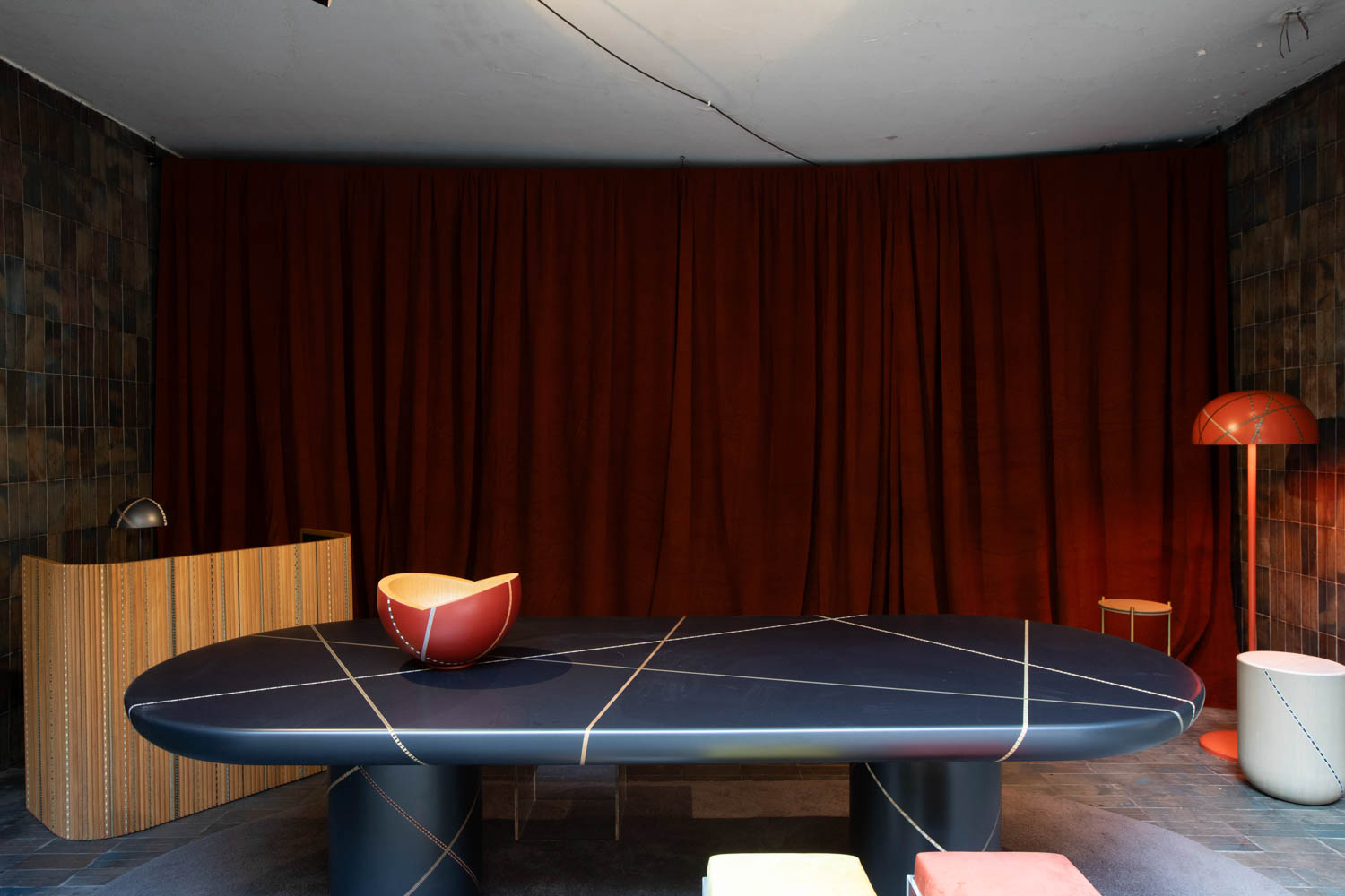 a dark gray table with an orange bowl