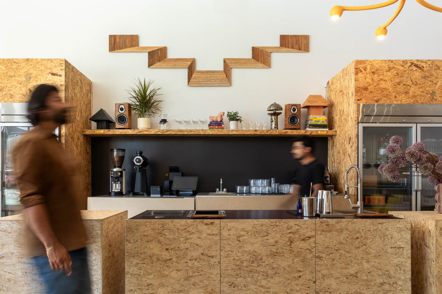 person walking in front of coffee area