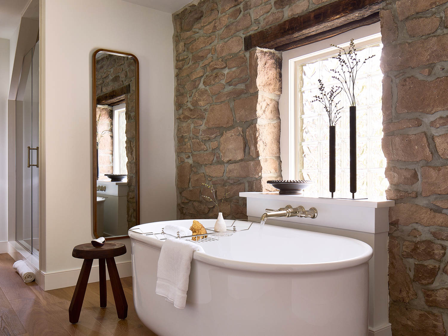 bathroom with brick wall and freestanding tub