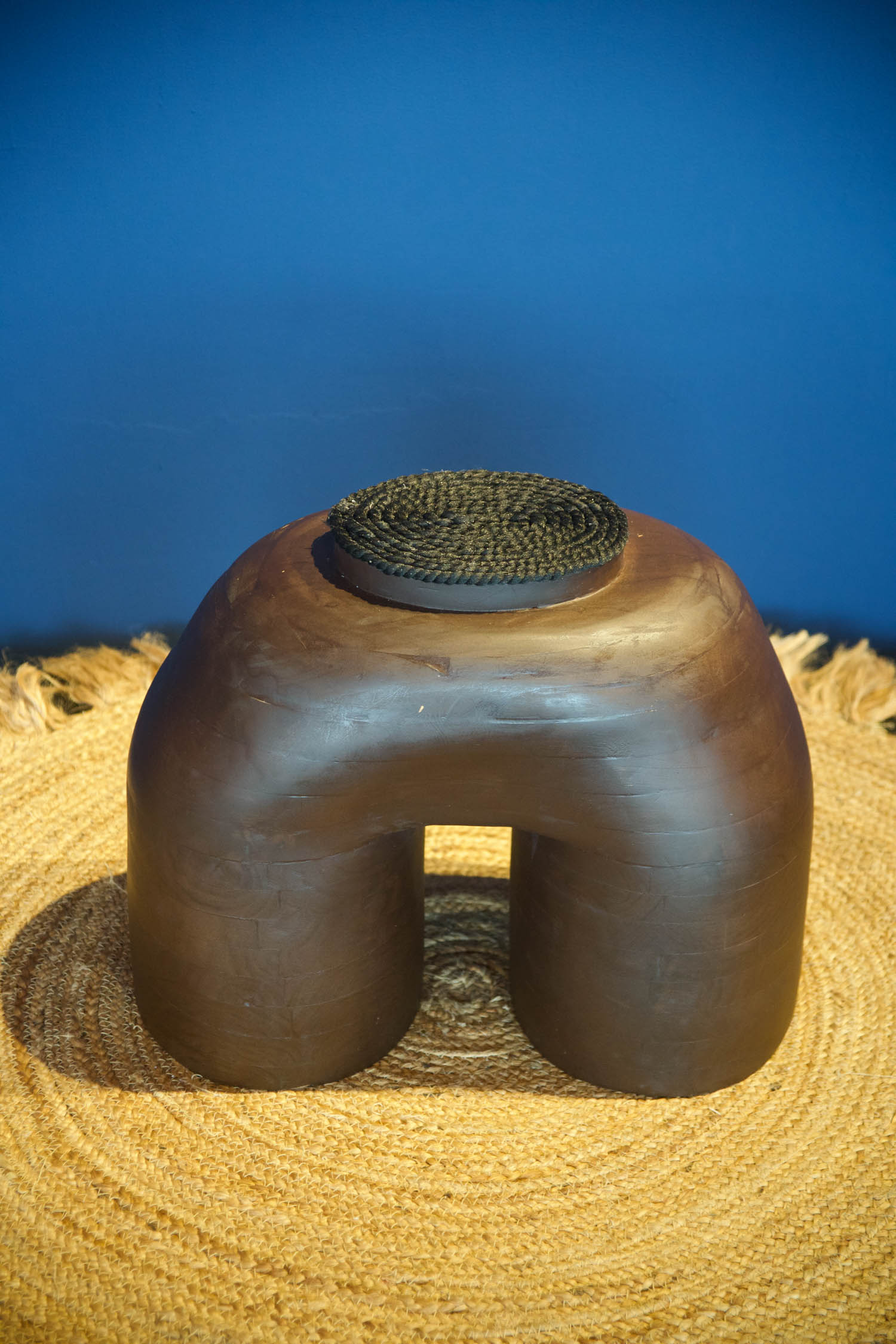 brown stool on a straw carpet