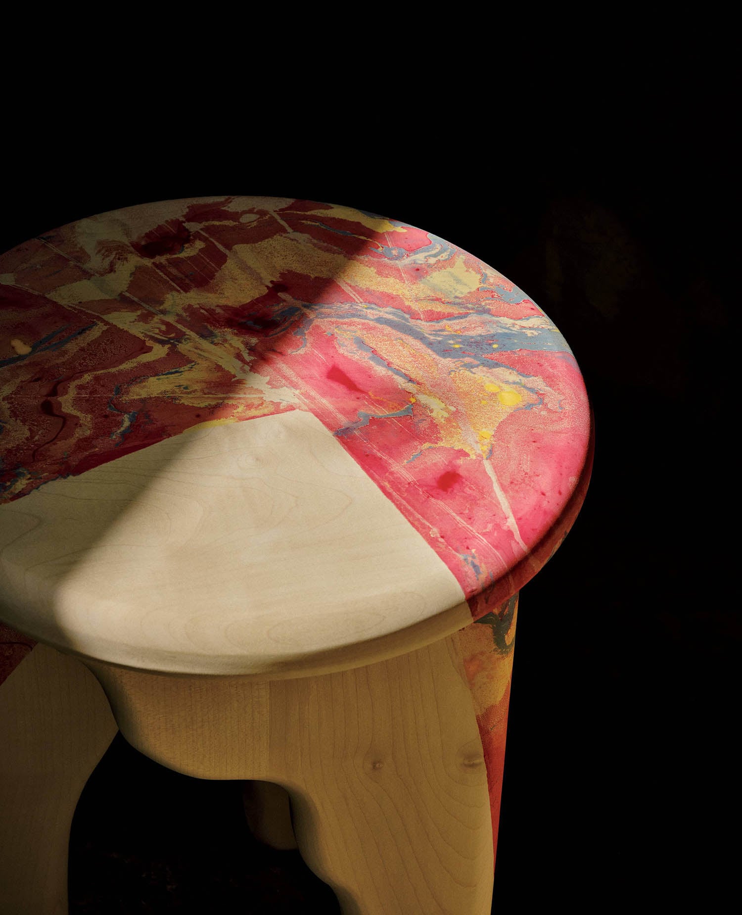 A wooden stool with a painted surface.