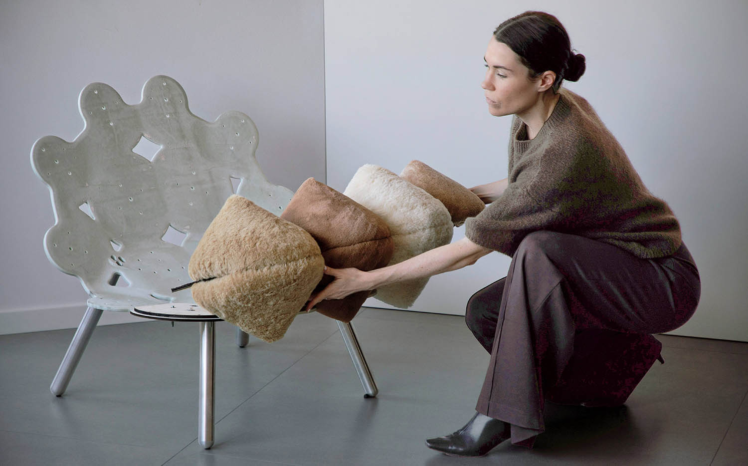 A woman sitting on a chair with a teddy bear.