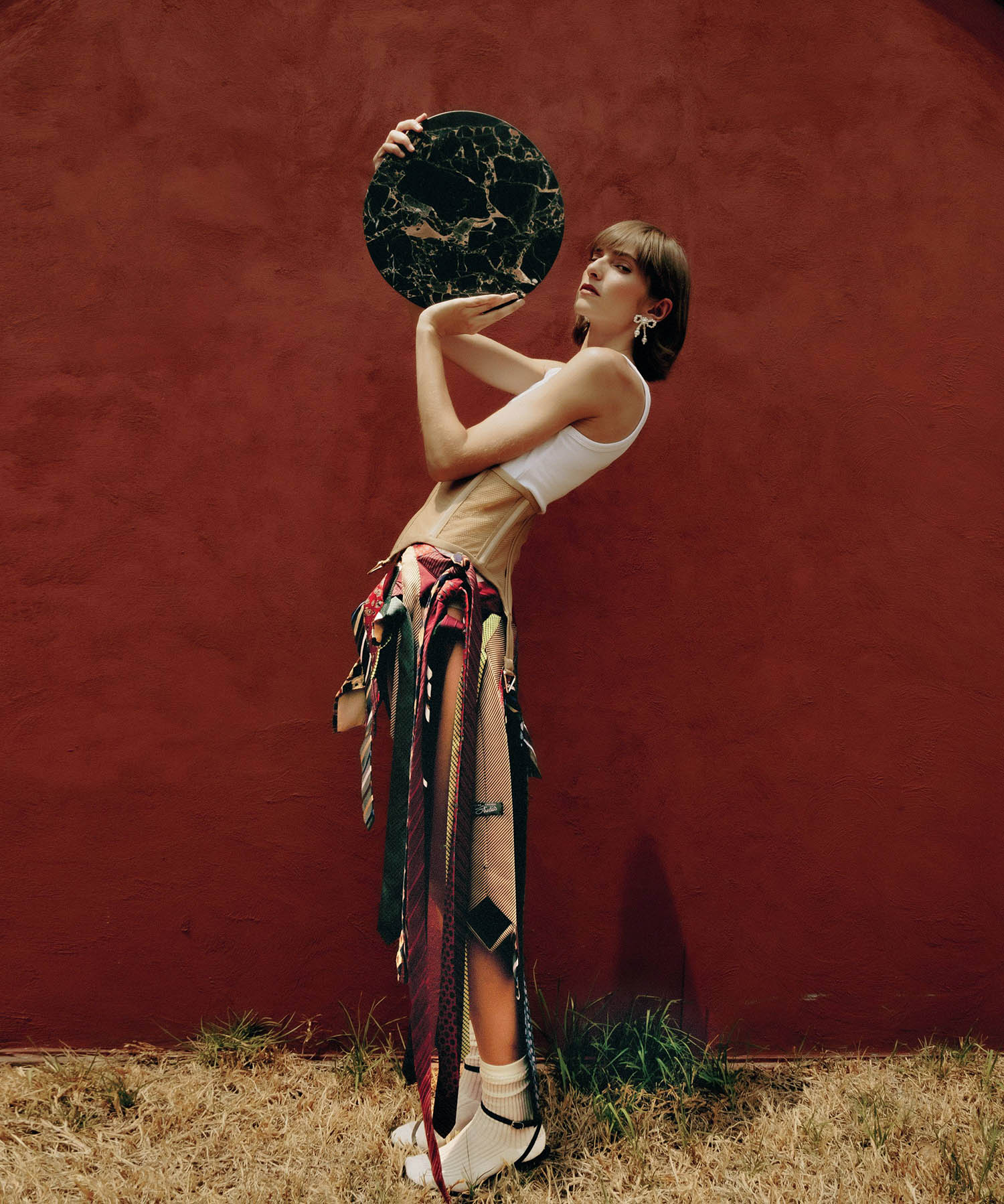 A woman holding a large black object in her hands.