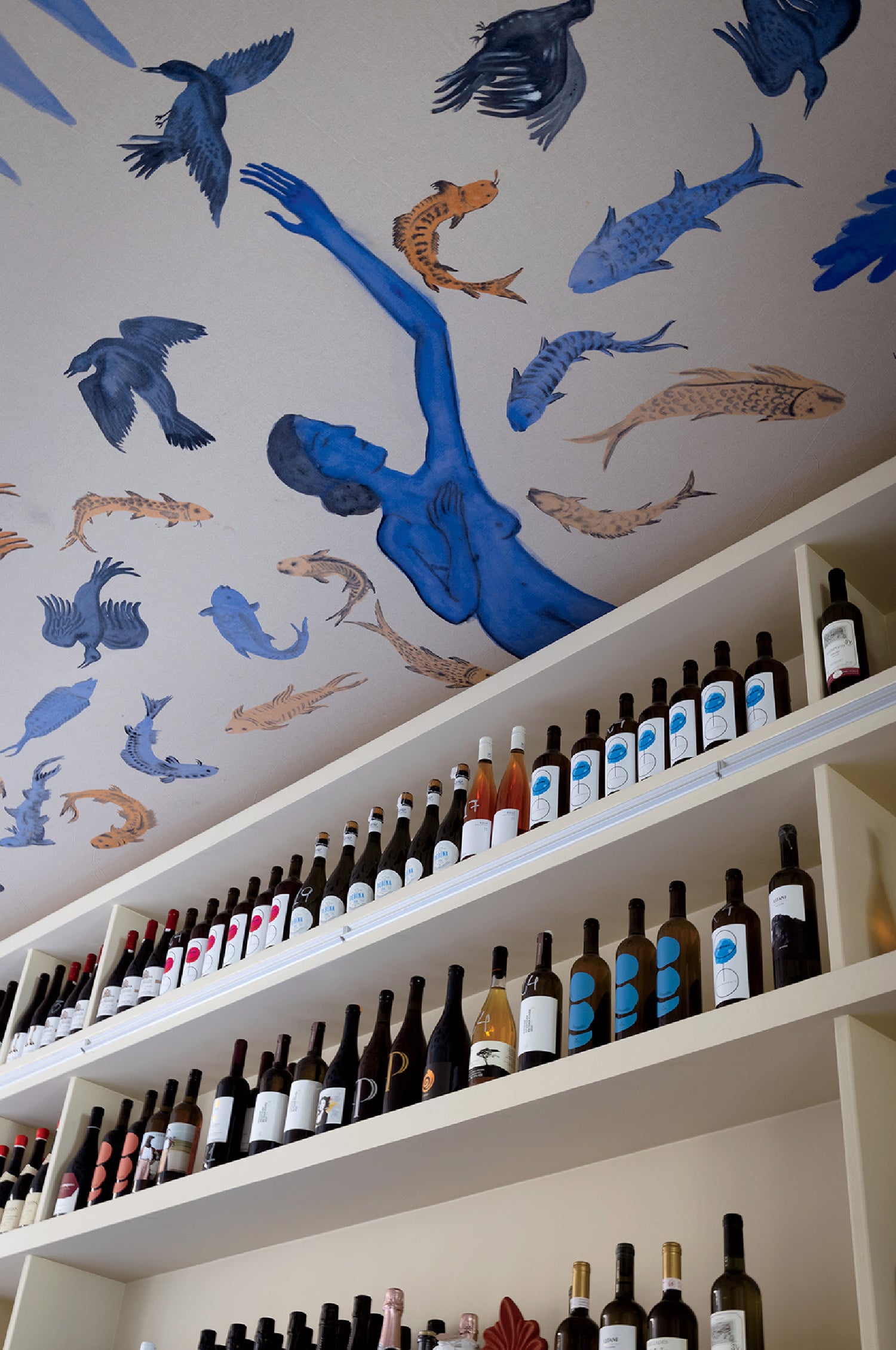 A wall with a mural of birds on it