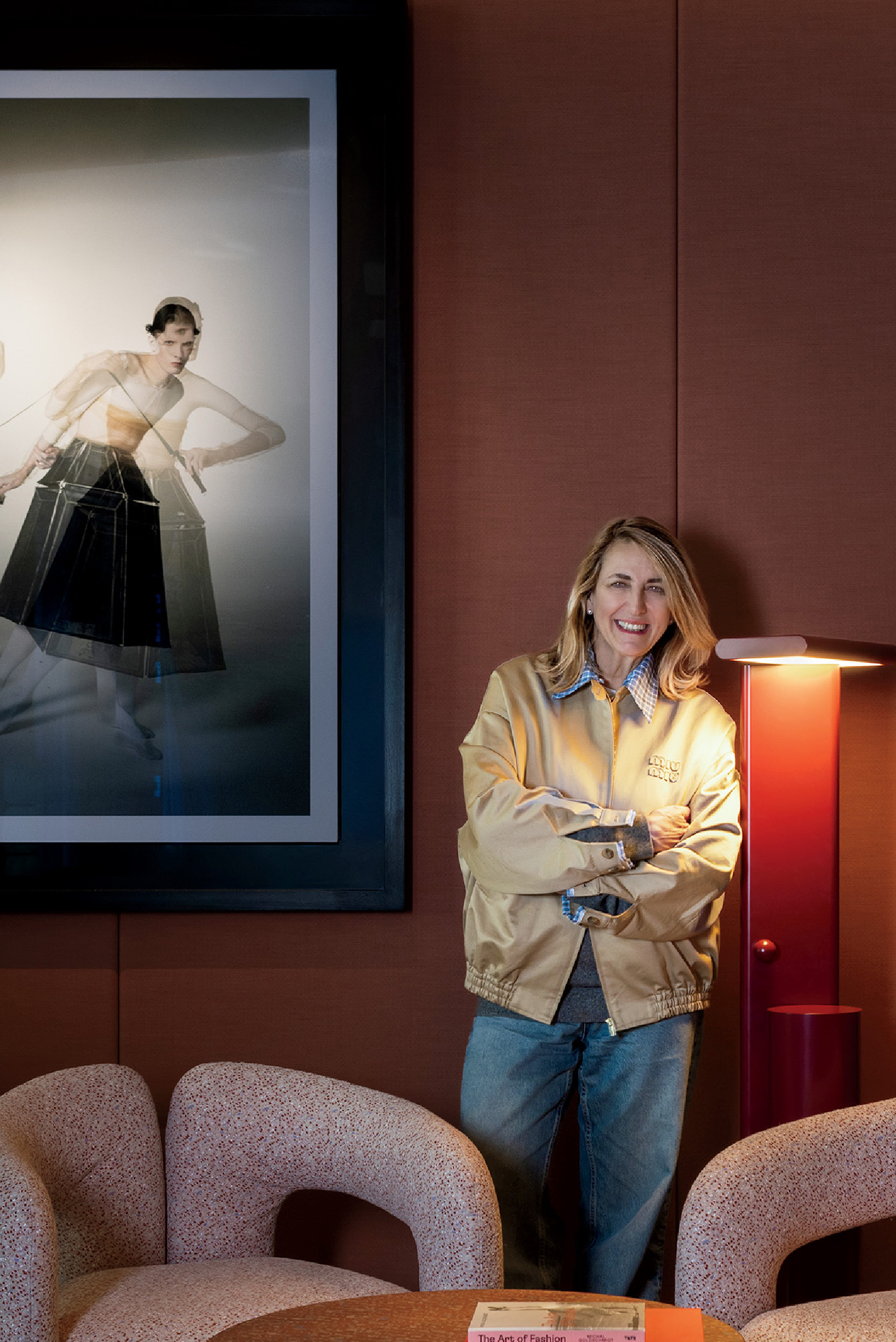 A woman standing in a room with a picture of a woman