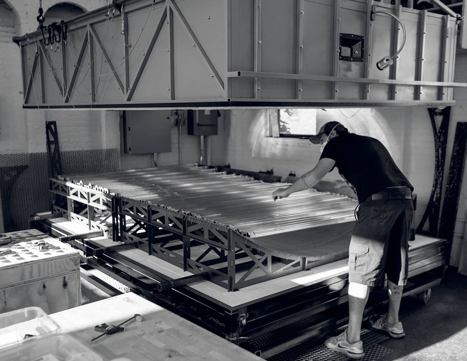 A man working on a metal table in a factory