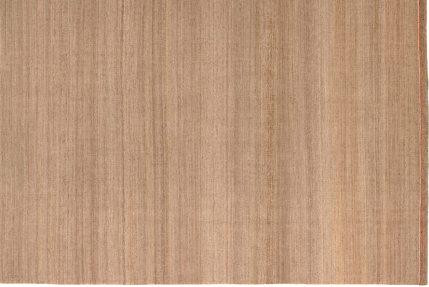 A beige rug with a white background