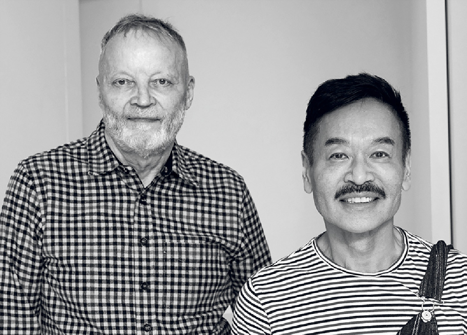 Two men standing next to each other man