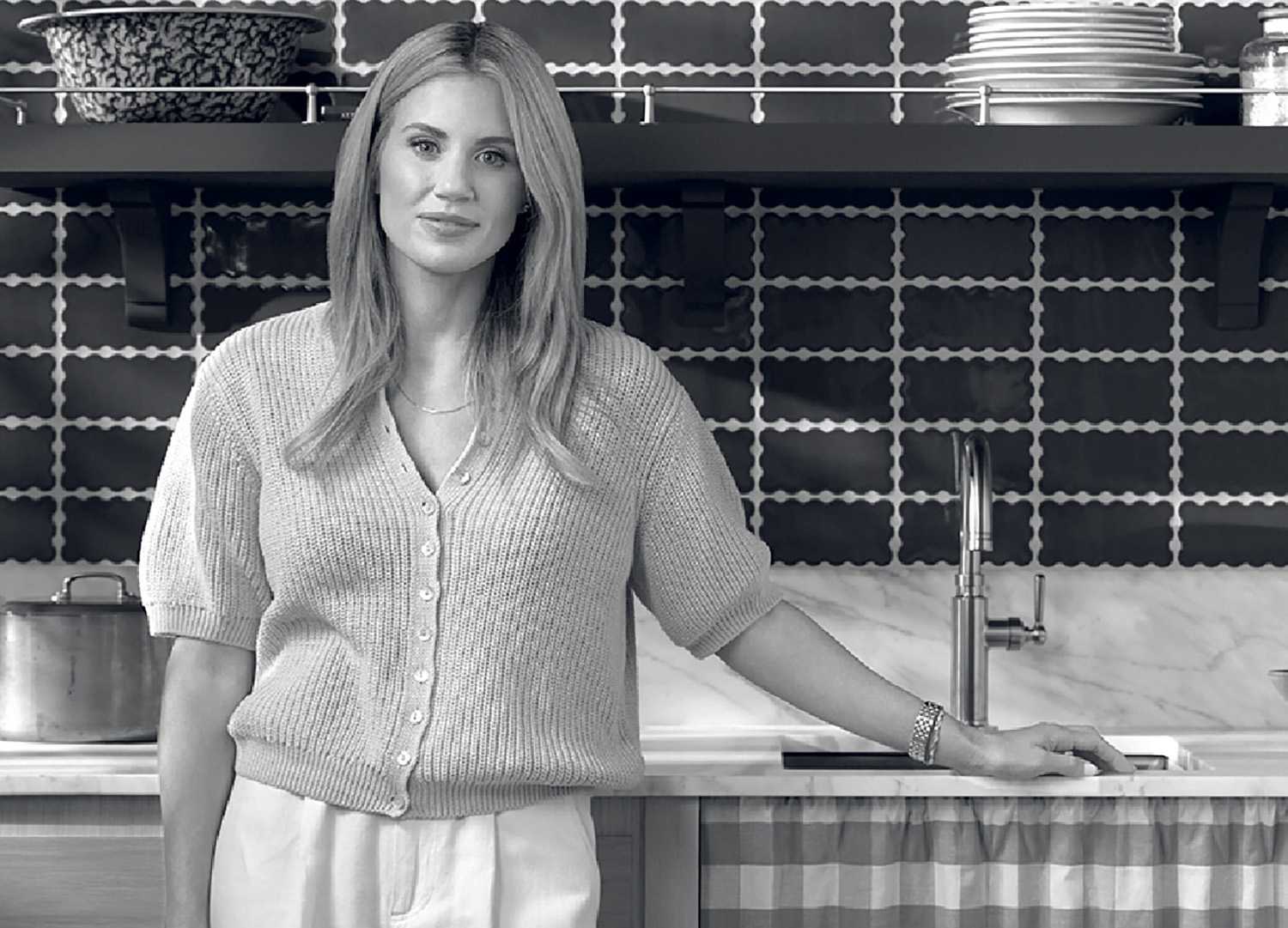 A woman standing in a kitchen with a counter