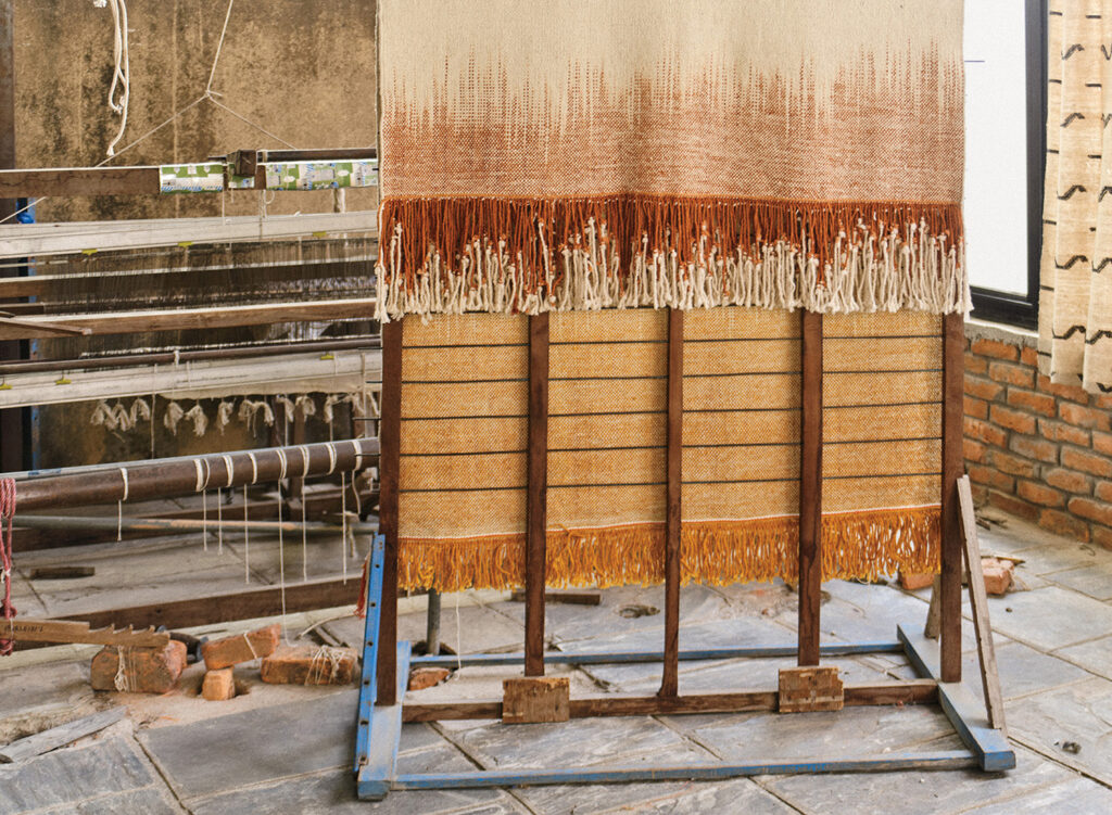 A piece of cloth is being made on a stand