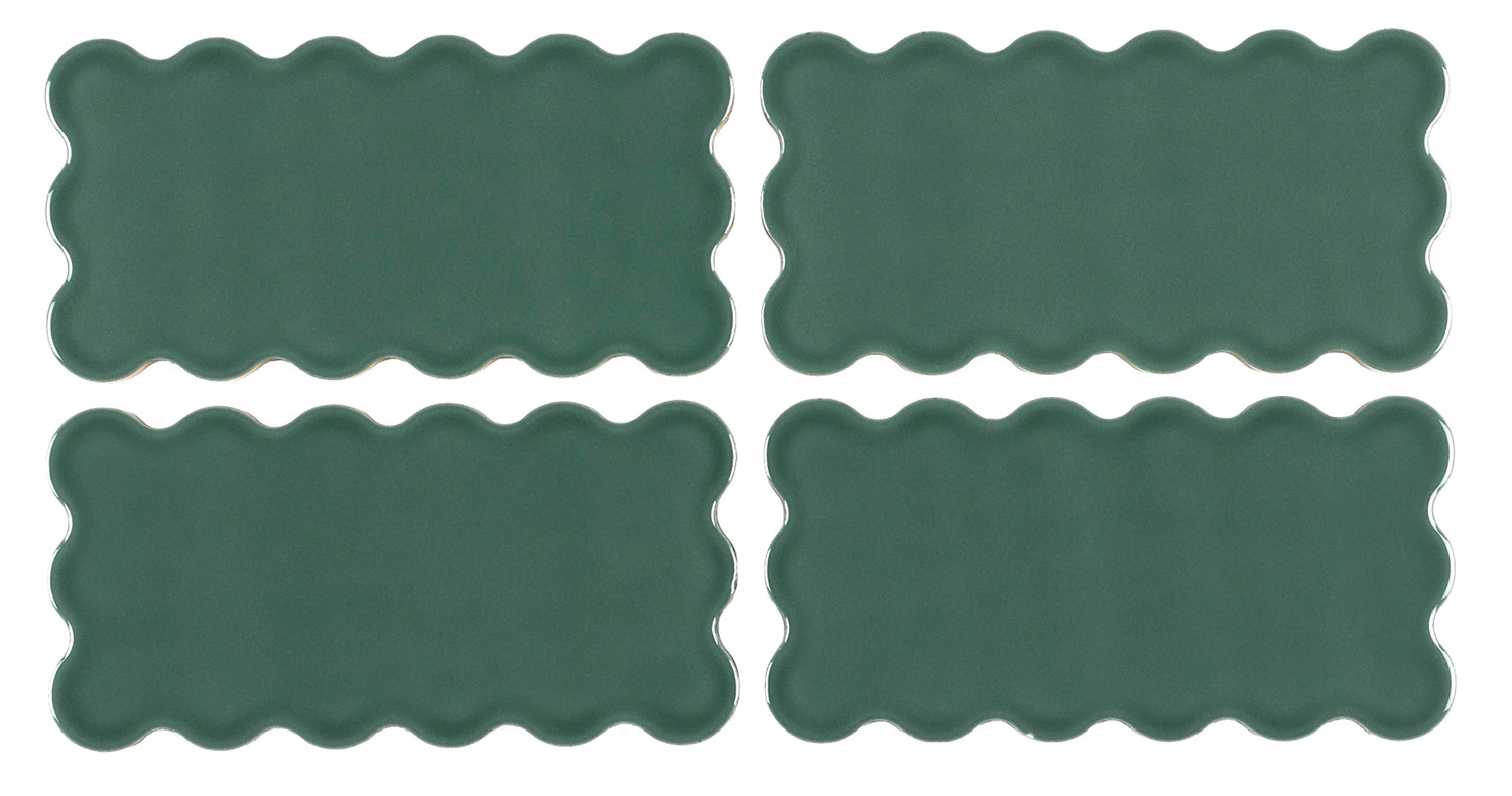 A set of four dark green ceramic tiles